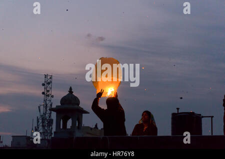 Jaipur, India - 14th Jan 2017: People release a chinese lantern into the air as part of Makar Sankranti or Uttaryan celebration in Rajasthan India. This is a recent trend Stock Photo