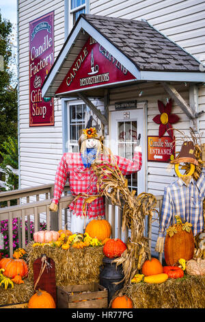 A candle shop with a fall arrangement of pumkins and scare crows in Walnut Creek, Ohio, USA. Stock Photo