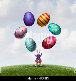 Rabbit juggling Easter eggs as a cute seasonal bunny mascot playing with magical decorated spring holiday symbols with 3D illustration elements. Stock Photo