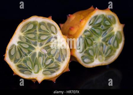 Kiwano fruit cut in half on black background Stock Photo