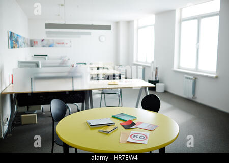 Image of modern work space in grey and white with meeting table in front Stock Photo