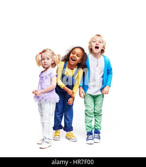 Studio portrait of children against white background:  full body shot of three kids in colorful clothes, African girl, blond boy and cute little girl, Stock Photo
