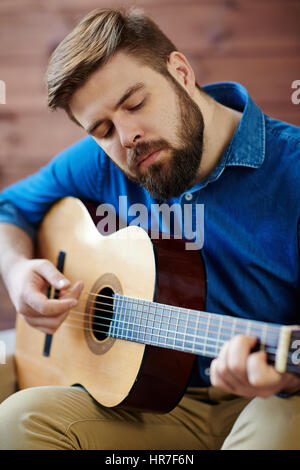 Young man composing the song and sitting on a floor Stock Photo Alamy