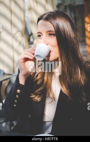 young authentic business woman in the city for a buisness travel - coffee break Stock Photo