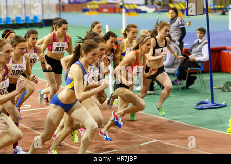 SUMY, UKRAINE - FEBRUARY 17, 2017: start of final race 3000m on Ukrainian indoor track and field championship 2017. In the middle running Nataliya Tobias Stock Photo