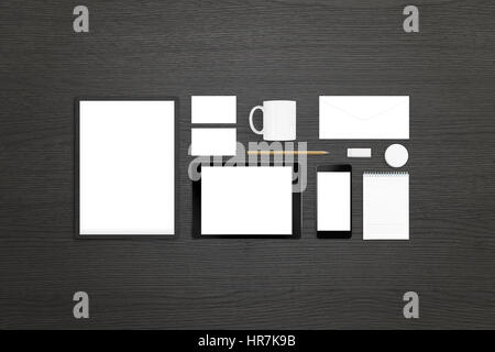Tablet, mobile phone with isolated white screen, stationery and office supplies for design, logo, and visual identity presentation. Top view of black  Stock Photo