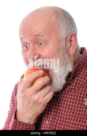 Cheerfull senior man eating the apple, isolated on white Stock Photo