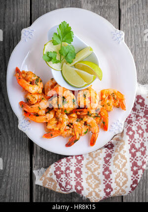 Fried Prawns with lemon served on a wooden surface. Stock Photo
