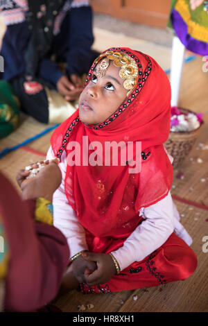 Muscat, Oman - Feb 4, 2017: Young Omani girl during a traditional wedding ritual display at Muscat cultural festival. Stock Photo