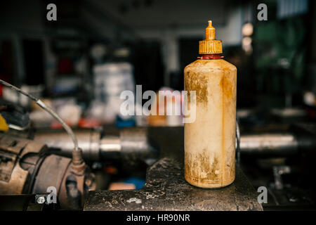 old plastic bottles for oil in the mechanical workshop Stock Photo