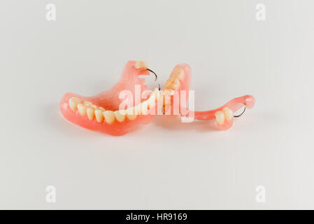 acrylic denture with metal clasps for restoring dentition Stock Photo