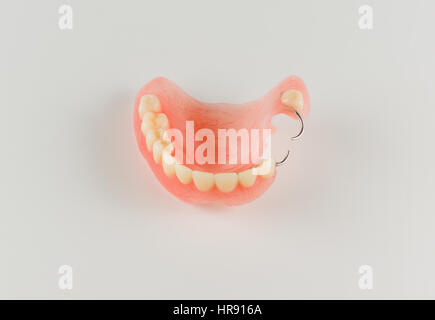 acrylic denture with metal clasps for restoring dentition Stock Photo