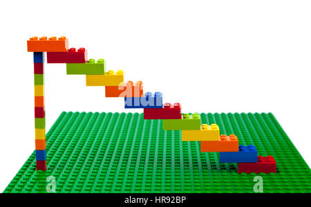 Colourful Lego brick construction of staircase or artwork  on a green Lego base plate. Stock Photo