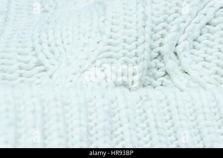 knitted fabric texture. Knitted jersey background with a relief pattern. Braids in knitting Stock Photo