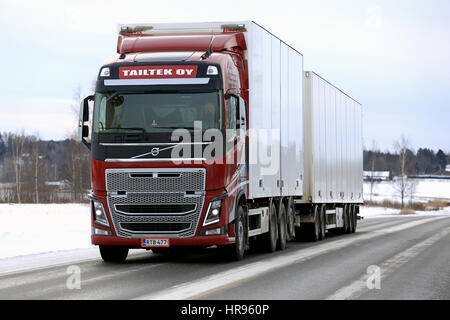 SALO, FINLAND - FEBRUARY 25, 2017: Red Volvo FH16 tractor trailer combination of Tailtek Oy transports goods along highway on a cloudy day of winter. Stock Photo