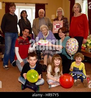 Elderly woman in wheelchair celebrating her 101st birthday surrounded by her extended family and staff members in residential care home, Alton, UK. Stock Photo