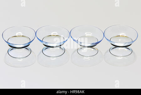 Four soft contact lens on the mirror surface