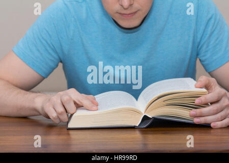 young student reading book on desk Stock Photo