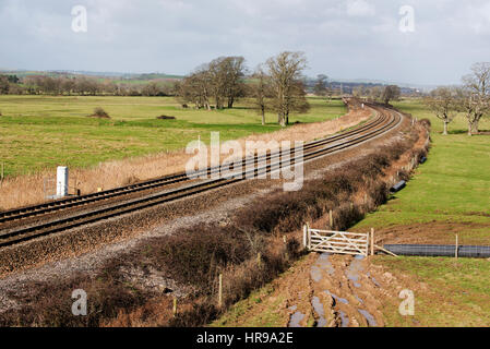 Railway lines crossing countryside on an embankment looking towards Exeter in south Devon England UK Stock Photo