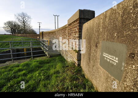 2013 tidal surge level marker on the bridge over Mill Basin where it enters the River Great Ouse at Eau Brink in the Norfolk Fens, Fenland UK. Stock Photo