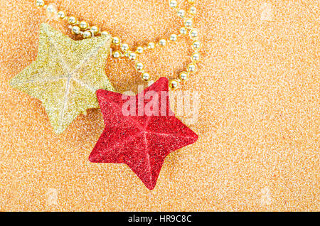 Red and gold star glitter decoration for christmas on gold background. Stock Photo