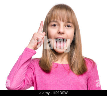 Cute little girl pointing up, gesturing idea or doing number one gesture. Conceptual close-up emotional portrait of caucasian child. Funny kid, isolat Stock Photo