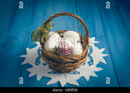 Group of eggs on the blue wooden surface. Easter concept. Stock Photo