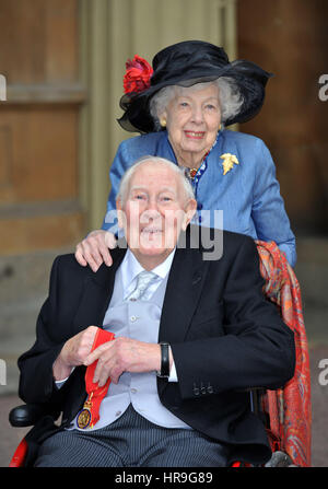 Sir Roger Bannister, 87, who was the first man to break the four-minute mile, at Buckingham Palace in central London with his wife Moyra, after receiving his award as a Companion of Honour from the Duke of Cambridge. Stock Photo