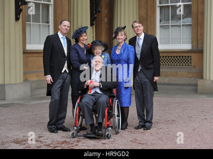 Sir Roger Bannister, 87, who was the first man to break the four-minute mile, at Buckingham Palace in central London with family members including his sons Clive (left) and Thurstan (right), his wife Moyra (centre) and his daughter Erin (second right), after receiving his award as a Companion of Honour from the Duke of Cambridge. Stock Photo