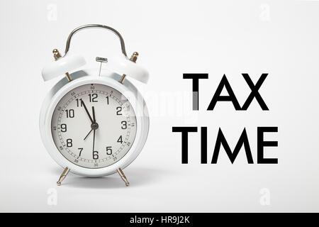 White old clock with text TAX TIME Stock Photo