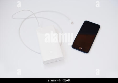 Hai, Ukraine - February 28, 2017:  Xiaomi power bank 20000 mah with Apple Iphone 7 isolated on white background. Stock Photo