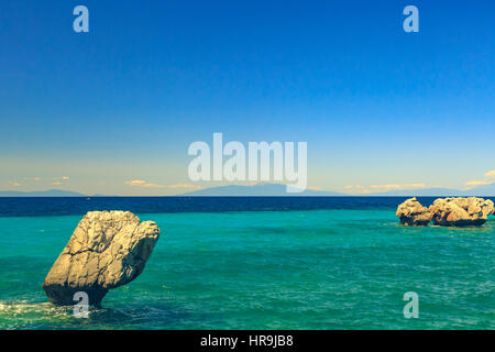 The rocky coast overlooking the turquoise blue sea in the warm summer day. Greece. Halkidiki Stock Photo