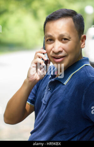 Man using mobile phone outdoor Stock Photo