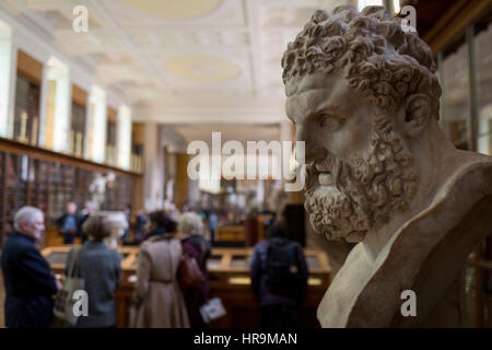 The bust of mythical Hercules, a Roman copy of the ancient Greek original by Lysippos (of about 325-300BC) overlooks the Enlightenment Gallery of the British Museum on 28th February 2017, in London, England. The Roman version is said to have been found in lava at the foot of Vesuvius and presented to the museum by Sir William Hamilton in 1776. Hercules is the Roman adaptation of the Greek divine hero Heracles,  the son of Zeus (Roman equivalent Jupiter) and the mortal Alcmene. In classical mythology, Hercules is famous for his strength and for his numerous far-ranging adventures. Stock Photo