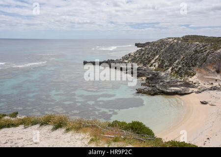 Turquoise Indian Ocean seascape with remote bay, reef and limestone rock in the dunes at Rottnest Island in Western Australia. Stock Photo