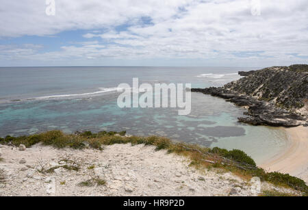 Turquoise Indian Ocean seascape with remote bay, reef and limestone rock in the dunes at Rottnest Island in Western Australia. Stock Photo