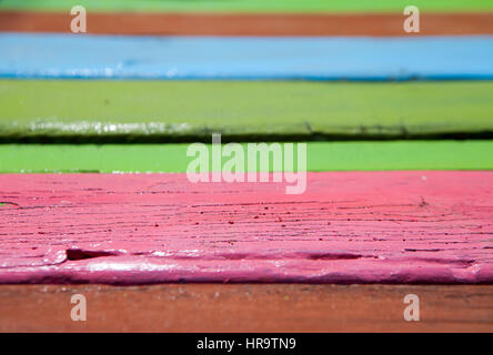 Patterned and textures background of brightly colored panels of weathered painted wooden boards Stock Photo