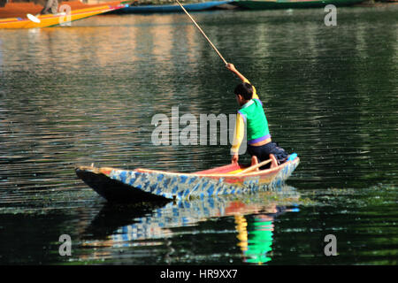 A Kashmiri boy enjoys a lazy day fishing on Dal Lake in Srinagar, Kashmir (Photo Copyright © by Saji Maramon) Stock Photo