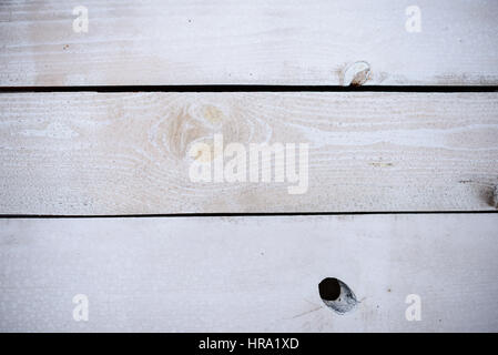 old wooden boards painted white and with various cracks Stock Photo