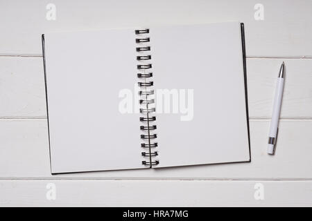 notebook and pen on white wooden desk Stock Photo