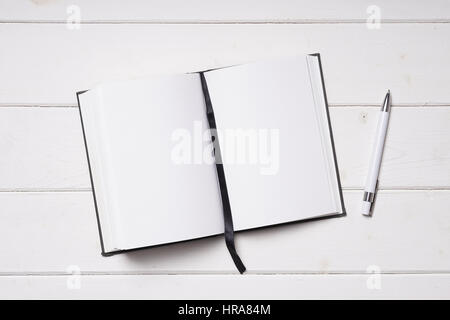 open notebook and pen on white wooden desk Stock Photo