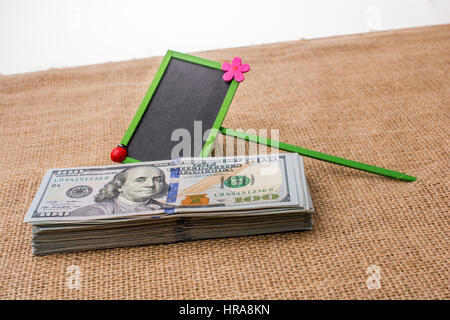Notice board placed on the bundle of US dollar banknote Stock Photo - Alamy
