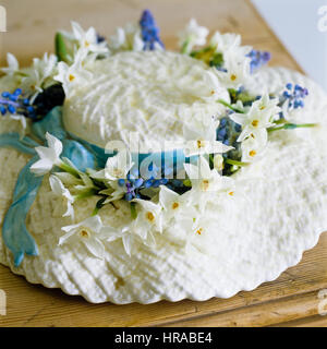 A cake in the shape of a hat with flowers. Stock Photo