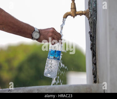 FILLING PLASTIC WATER BOTTLE FROM TAP IN SULTANAHMET SQUARE GARDEN ISTANBUL TURKEY Stock Photo