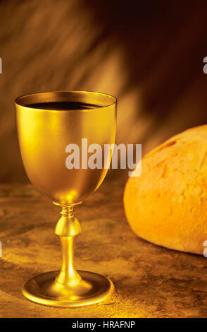 Wine Goblet and Broken Bread, Symbols of Communion Stock Photo