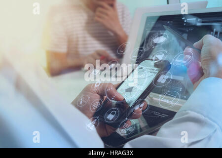 Designer Businessman hand using smart phone,mobile payments online shopping,omni channel,digital tablet docking keyboard computer in modern office on  Stock Photo