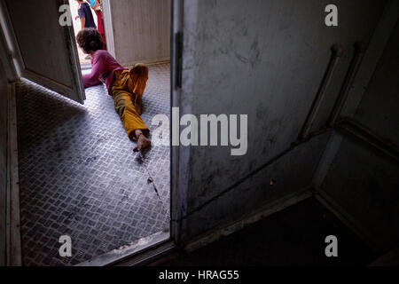 A mentally handicapped refugee girl age 9, chained to a toilet by the ankle in Zakho IDP camp near Dohuk, Kurdistan, Iraq. Stock Photo