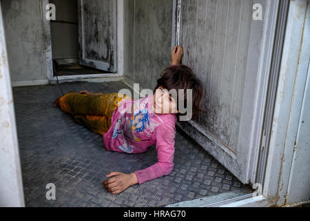 A mentally handicapped refugee girl age 9, chained to a toilet by the ankle in Zakho IDP camp near Dohuk, Kurdistan, Iraq. Stock Photo