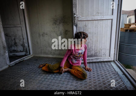 A mentally handicapped refugee girl age 9, chained to a toilet by the ankle in Zakho IDP camp near Dohuk, Kurdistan, Iraq. Stock Photo