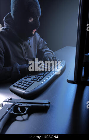 Computer hacker - Male thief stealing data from laptop Stock Photo